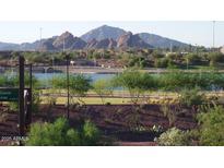 Scenic lake view with lush landscaping, mountain views, and walking path at 525 W Lakeside Dr # 151, Tempe, AZ 85281
