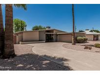 Charming home featuring a circular driveway and desert landscaping at 5420 N Granite Reef Rd, Scottsdale, AZ 85250