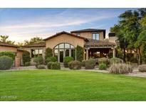 Charming home with a well-manicured lawn, mature landscaping, and a covered entryway at 7710 E Golden Eagle Cir, Gold Canyon, AZ 85118