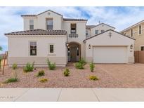 Charming two-story home with a well-manicured front yard and a two-car garage at 8817 W Denton Ln, Glendale, AZ 85305