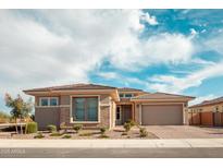 Charming single-story home with a well-maintained front yard and a paver driveway leading to an attached two-car garage at 11019 E Tiburon Ave, Mesa, AZ 85212