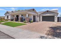 Charming single-story home boasts a well-manicured lawn and a spacious driveway at 1500 E Sagittarius Pl, Chandler, AZ 85249