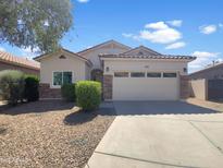 Charming single-story home with well-manicured landscaping and a two-car garage at 19707 N Pepka Ct, Maricopa, AZ 85138