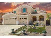 Charming two-story home with desert landscaping, attached two-car garage and barrel tile roof at 2036 E Carob Dr, Chandler, AZ 85286