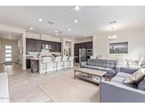 Bright, open-concept living area featuring modern kitchen with stainless steel appliances and a cozy sitting area at 23386 N 73Rd Way, Scottsdale, AZ 85255