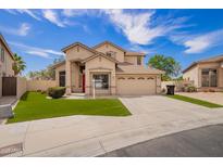 Charming two-story home featuring a red front door, desert landscaping, and a spacious two-car garage at 2602 E Glass Ln, Phoenix, AZ 85042