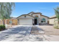 Charming single-story home featuring a two-car garage, arched entry, and desert landscaping for low maintenance at 2716 W Sunland Ave, Phoenix, AZ 85041