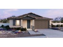 Charming single-story home featuring a two-car garage, stone accents, and a low-maintenance landscaped yard at 2988 E Mecklenburg Way, San Tan Valley, AZ 85143