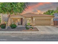 Charming single-story home with stone accents, a well-manicured yard, and a spacious two-car garage at 3214 N 138Th Dr, Avondale, AZ 85392