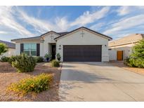Charming single-story home with a two-car garage and low-maintenance desert landscaping at 37790 W Santa Clara Ave, Maricopa, AZ 85138
