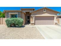 Charming single-story home with a well-maintained front yard and a two-car garage at 6180 W Oraibi Dr, Glendale, AZ 85308