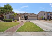 Inviting single-story home boasting a lush lawn, brick walkway, and a two-car garage at 6827 W El Cortez Pl, Peoria, AZ 85383