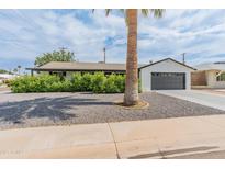 Charming single-story home with a manicured front yard and attached two-car garage at 7802 E Hubbell St, Scottsdale, AZ 85257
