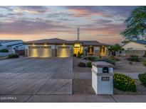 Charming single-story home boasts a three-car garage, desert landscaping, and a mailbox with the house number at 8132 W Hatfield Rd, Peoria, AZ 85383