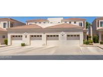 Exterior image of three garages with red tile roofing on a sunny day at 8270 N Hayden Rd # 2041, Scottsdale, AZ 85258