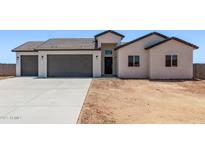 Charming single-story home featuring a spacious three-car garage and a low-maintenance desert landscape at 9429 W Sandstone Mountain Dr, Casa Grande, AZ 85194