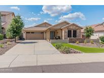 Charming single-story home featuring a well-manicured yard, stone accents, and a two-car garage at 12712 W Milton Dr, Peoria, AZ 85383