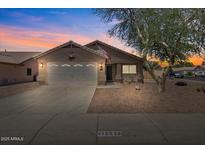 Charming single-story home with a two-car garage, desert landscaping, and a warm, inviting facade at 16538 N Oachs Dr, Surprise, AZ 85374