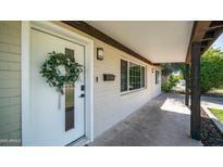 Inviting front porch featuring a white door adorned with a floral wreath at 1717 W Roma Ave, Phoenix, AZ 85015