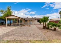 Charming single-story home featuring a covered carport and low-maintenance desert landscaping at 2130 W Colter St, Phoenix, AZ 85015