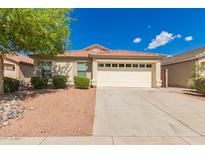 Charming single-story home with a well-manicured front yard and a spacious two-car garage at 29161 N Lilly Ln, San Tan Valley, AZ 85143