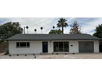 Charming single-story home featuring a low-pitch roof, freshly painted white exterior, and desert landscaping at 3933 E Flower St, Phoenix, AZ 85018
