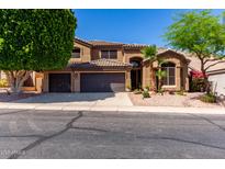 Beautiful two-story home featuring a three-car garage and well-manicured desert landscaping at 408 E Silverwood Dr, Phoenix, AZ 85048