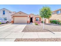 Charming single-story home featuring a desert landscape, two car garage, and covered entry at 4323 S Ranger Trl, Gilbert, AZ 85297