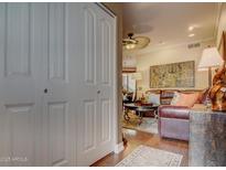 Inviting living room featuring hardwood floors and a comfortable leather sofa, perfect for relaxing and entertaining guests at 6900 E Princess Dr # 1176, Phoenix, AZ 85054