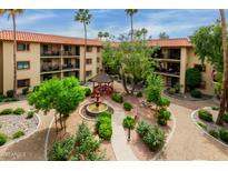 An aerial view of a well manicured courtyard featuring a gazebo, mature trees, and well-kept landscaping at 10330 W Thunderbird Blvd # A301, Sun City, AZ 85351