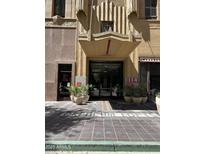 Orpheum Lofts entrance boasts a covered entrance, detailed architecture, and nearby shops in a vibrant city setting at 114 W Adams St # 302, Phoenix, AZ 85003