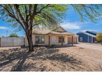 Charming single-story home featuring desert landscaping, attached two-car garage, and mature shade tree in the front yard at 12613 N 51St Dr, Glendale, AZ 85304