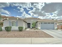 Charming single-story home featuring desert landscaping, neutral stucco, a two-car garage, and a tile roof at 1383 E Prescott Pl, Chandler, AZ 85249