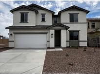 Inviting two-story home with a two-car garage and a well-maintained front yard with desert landscaping at 17481 W Fulton St, Goodyear, AZ 85338