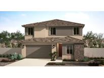 Charming two-story home featuring a stone facade, attached garage, and well-manicured landscaping in a suburban setting at 18186 W Larkspur Dr, Goodyear, AZ 85338