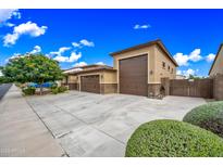 Spacious three-car garage with a large driveway, offering ample parking and convenient access at 18495 W Rimrock St, Surprise, AZ 85388