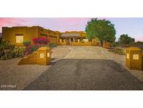 Stunning home featuring colorful flowering bushes, mature trees, and a long driveway at 19834 W Minnezona Ave, Litchfield Park, AZ 85340