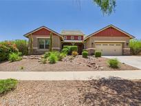 Charming single-story home showcasing desert landscaping, attached garage, and a welcoming covered entrance at 20615 W Daniel Pl, Buckeye, AZ 85396