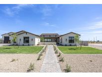 Inviting home featuring a neatly manicured lawn and a charming paved walkway, enhancing its curb appeal at 2087 N 77Th Pl, Mesa, AZ 85207
