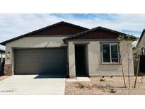 Charming single-story home featuring a two-car garage and low maintenance desert landscaping at 25137 W Wayland Dr, Buckeye, AZ 85326