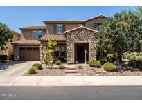 Charming two-story home featuring a stone facade, desert landscaping, and a welcoming entrance at 3664 E Narrowleaf Dr, Gilbert, AZ 85298