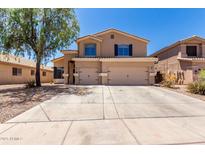 Two-story home with a large concrete driveway and a three-car garage at 4702 N 124Th Ave, Avondale, AZ 85392