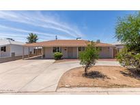 Charming single-level home featuring a covered carport and circular driveway at 6126 N 31St Dr, Phoenix, AZ 85017