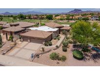 Beautiful desert home with tile roof, three car garage, and manicured landscaping with mountain views at 6162 E Redmont Dr, Mesa, AZ 85215