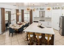 Bright open kitchen with island, marble countertops, stainless steel appliances, modern lighting, and breakfast nook at 84 E Joseph Way, Gilbert, AZ 85295