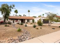 Charming single story home featuring desert landscaping and a cozy tile roof at 9637 E Gold Dust Ave, Scottsdale, AZ 85258