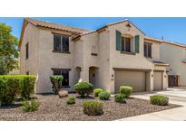 Charming two-story home with a well-manicured front yard and an attached two-car garage at 14129 W St Moritz Ln, Surprise, AZ 85379