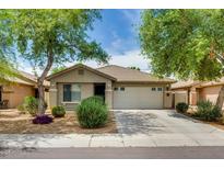 Attractive single-story home with a tile roof, landscaped front yard and two-car garage at 17765 W Ventura St, Surprise, AZ 85388
