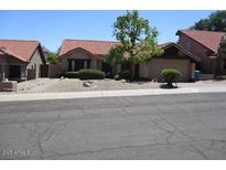 Charming single-story home with desert landscaping and a red tile roof at 1819 E Sheena Dr, Phoenix, AZ 85022