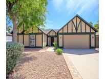 Charming home featuring a tidy front yard, mature tree, and a two car garage, inviting curb appeal at 20609 N 4Th Ave, Phoenix, AZ 85027